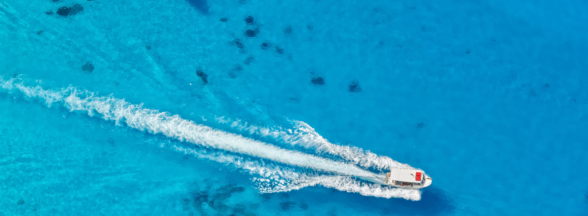 Aerial view of speed boat in azure sea - JT Boats